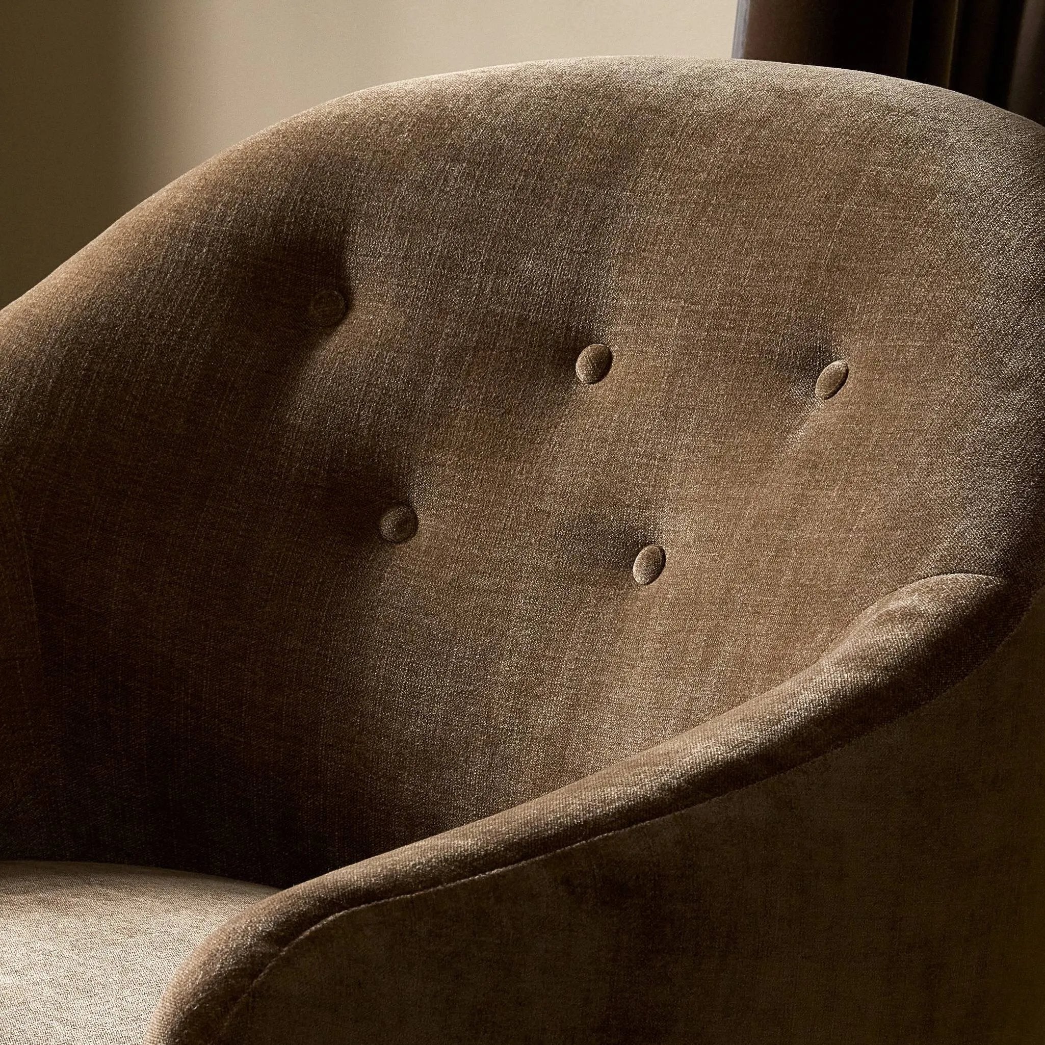 A traditional shape with modern styling, turned wooden legs complement the soft curves of this lounge-worthy chair. A chenill