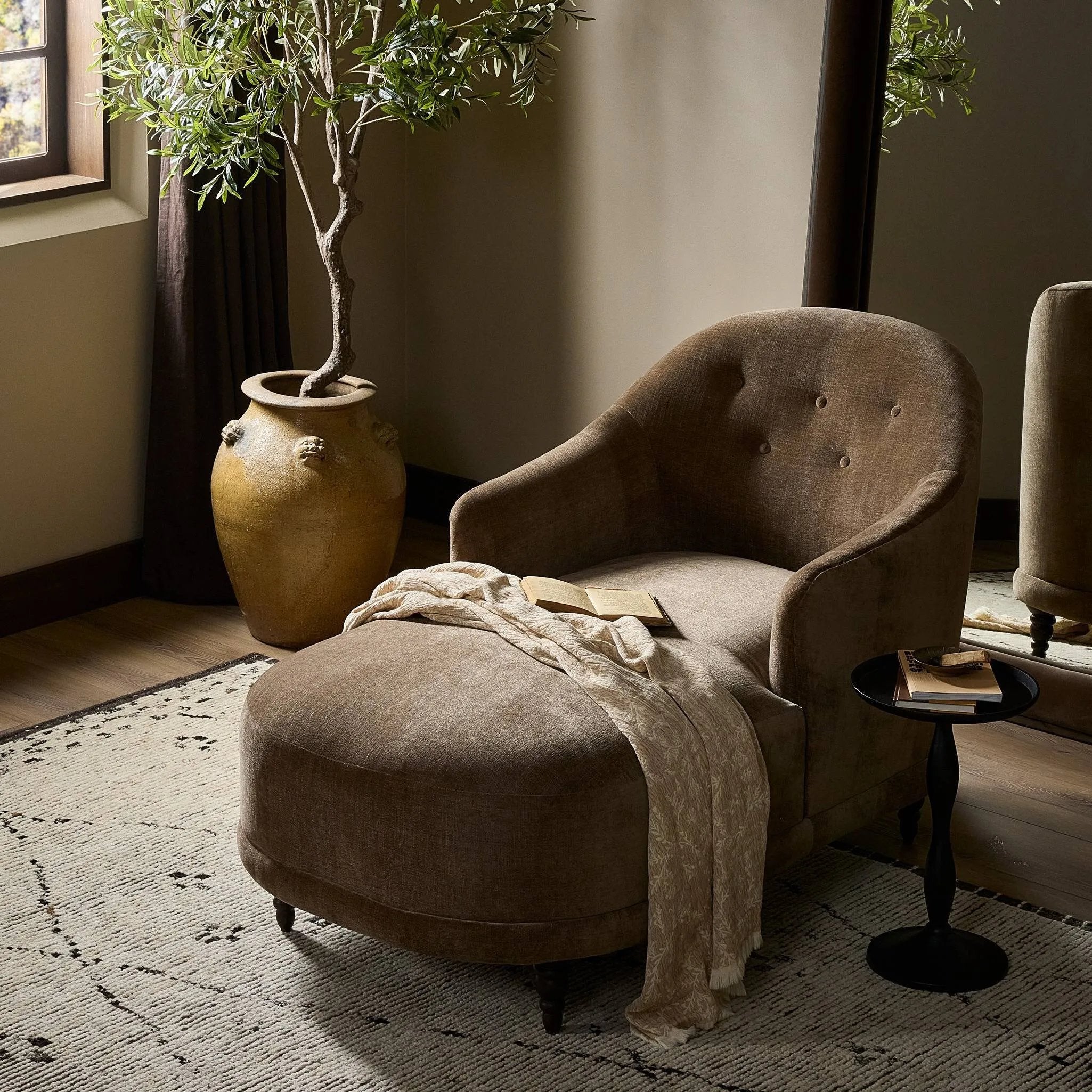 A traditional shape with modern styling, turned wooden legs complement the soft curves of this lounge-worthy chair. A chenill