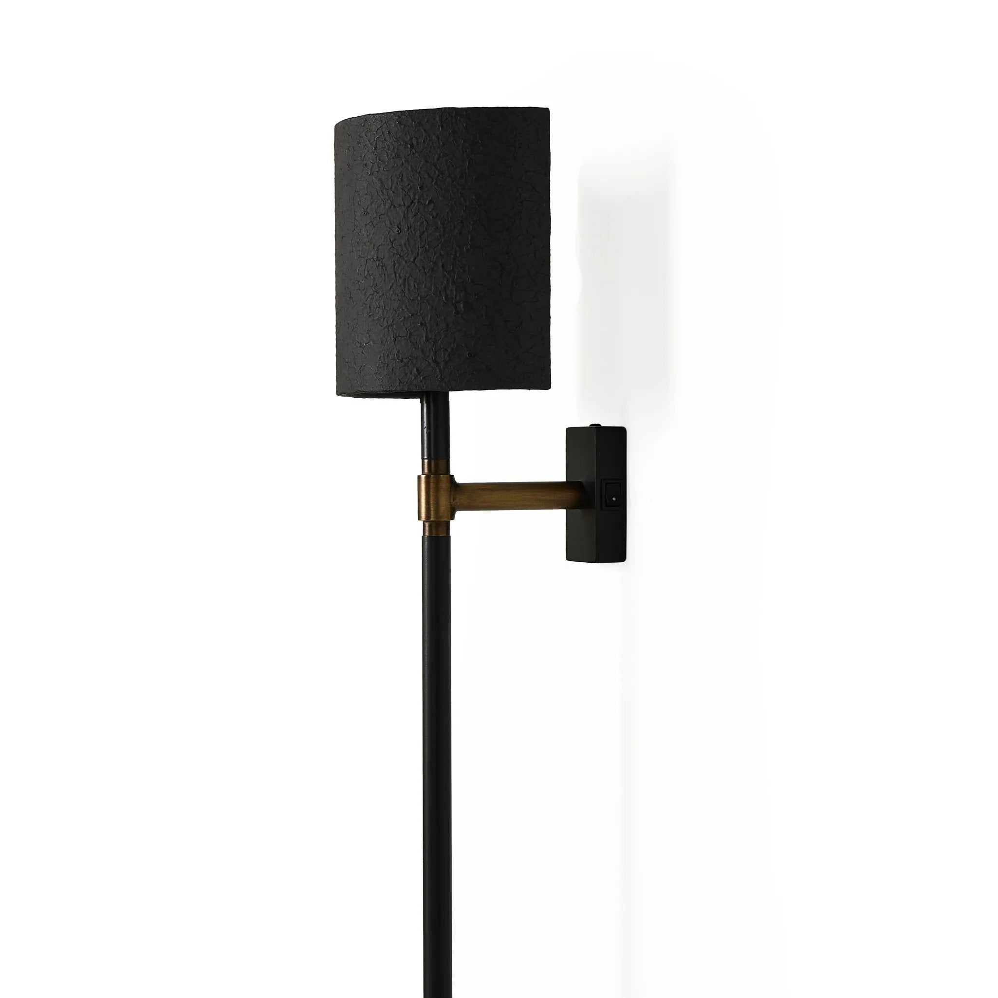 Featuring Maurice Matte Black Plaster Sconce by Four Hands at Amethyst Home. Housed behind a curved black shade, light beams with a soft glow both upward and downward from this plug-in sconce.  A  slim pole to hide the cord and a convenient switch on the backplate create a seamless look.Overall Dimensions: 8.00"w x 7.50"d x 50.00"hWeight : 6.61 lbsMaterials:. Amethyst Home provides interior design, new home construction design consulting, vintage area rugs, and lighting in the Monterey metro area.