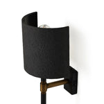 Featuring Maurice Matte Black Plaster Sconce by Four Hands at Amethyst Home. Housed behind a curved black shade, light beams with a soft glow both upward and downward from this plug-in sconce.  A  slim pole to hide the cord and a convenient switch on the backplate create a seamless look.Overall Dimensions: 8.00"w x 7.50"d x 50.00"hWeight : 6.61 lbsMaterials: Ir. Amethyst Home provides interior design, new home construction design consulting, vintage area rugs, and lighting in the Omaha metro area.