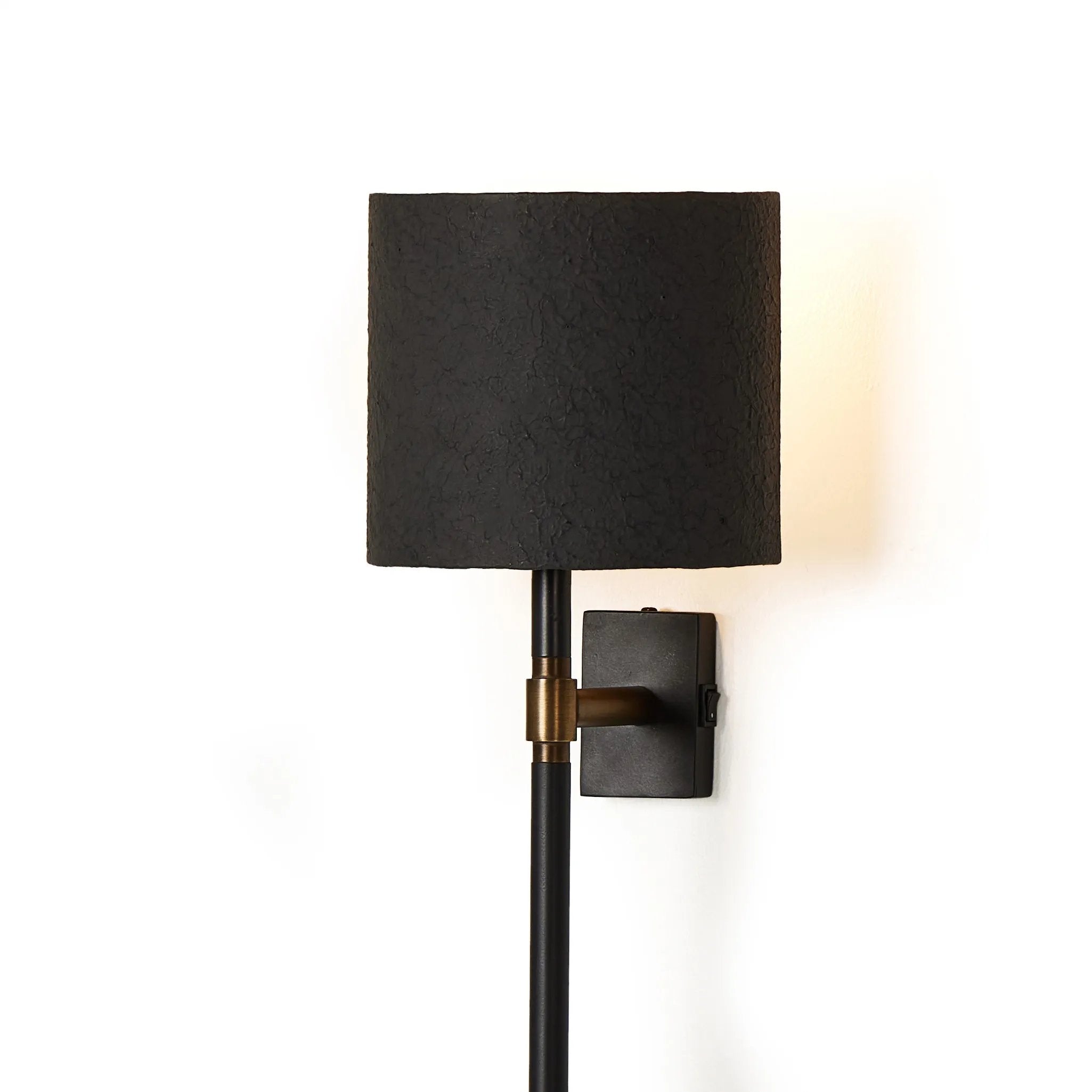 Featuring Maurice Matte Black Plaster Sconce by Four Hands at Amethyst Home. Housed behind a curved black shade, light beams with a soft glow both upward and downward from this plug-in sconce.  A  slim pole to hide the cord and a convenient switch on the backplate create a seamless look.Overall Dimensions: 8.00"w x 7.50"d x 50.00"hWeight : 6.61 lbsMaterials: Ir. Amethyst Home provides interior design, new home construction design consulting, vintage area rugs, and lighting in the Tampa metro area.
