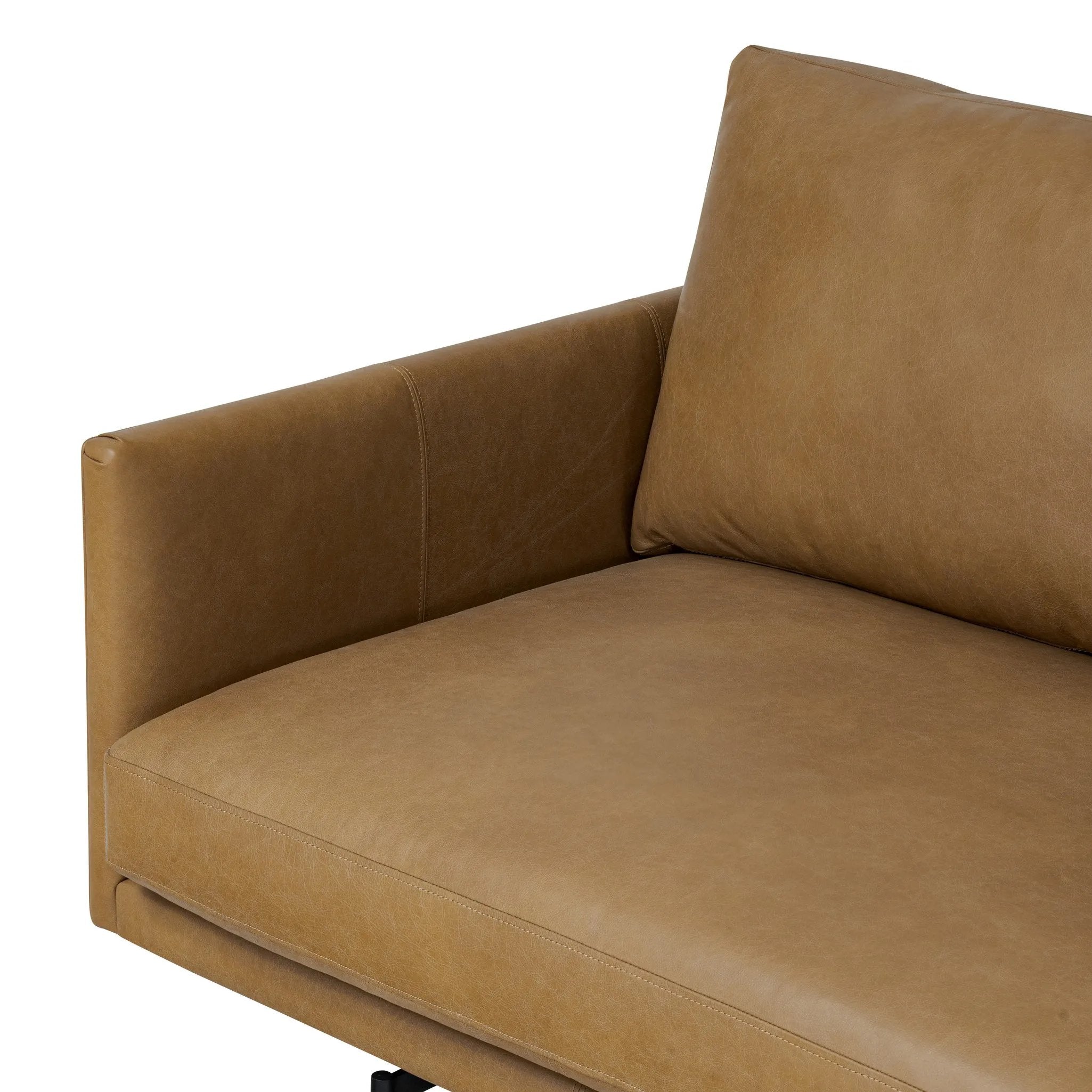 A minimalist form to redefine contemporary seating. Made from tan top-grain leather with a slim profile, expert tailoring and plush cushions for comfort. Sleek metal legs and compact sizing make this piece a versatile anchor for smaller living spaces Amethyst Home provides interior design, new home construction design consulting, vintage area rugs, and lighting in the Miami metro area.