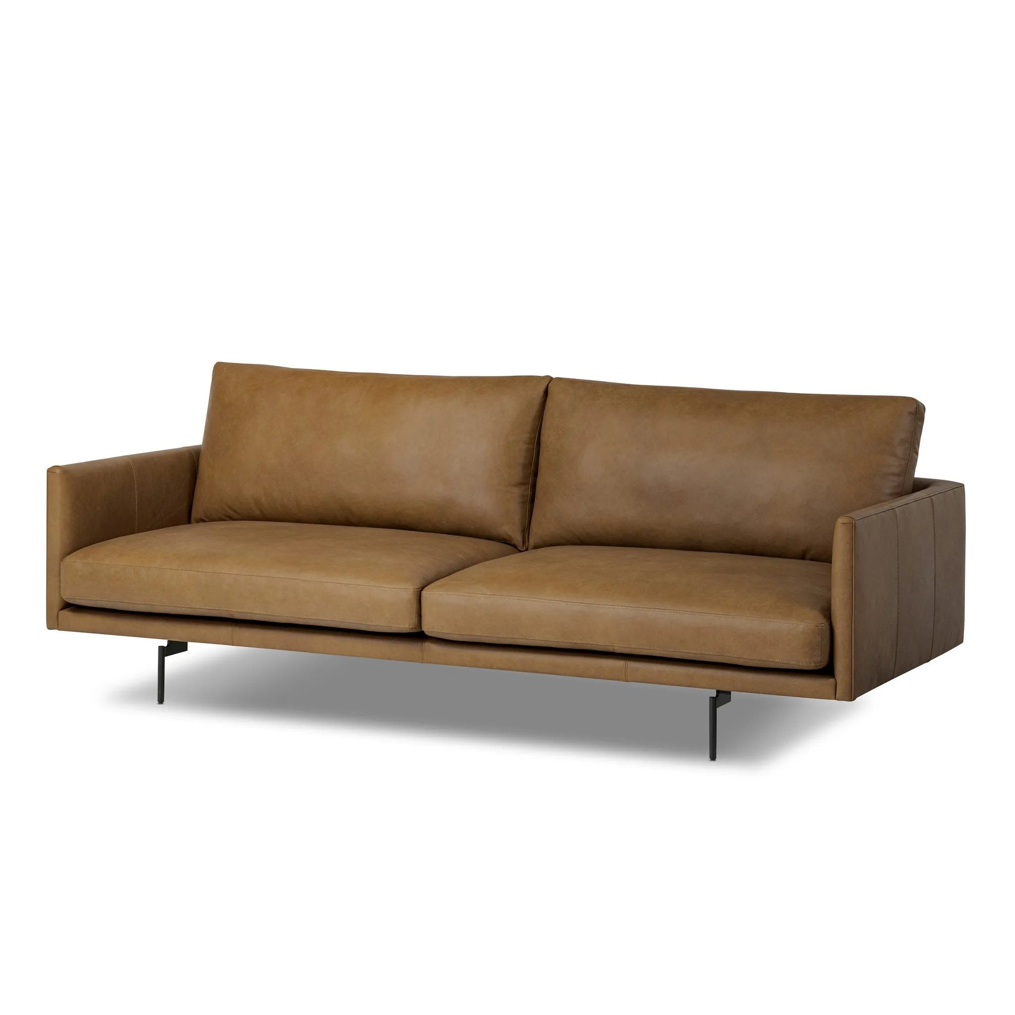 A minimalist form to redefine contemporary seating. Made from tan top-grain leather with a slim profile, expert tailoring and plush cushions for comfort. Sleek metal legs and compact sizing make this piece a versatile anchor for smaller living spaces Amethyst Home provides interior design, new home construction design consulting, vintage area rugs, and lighting in the Portland metro area.