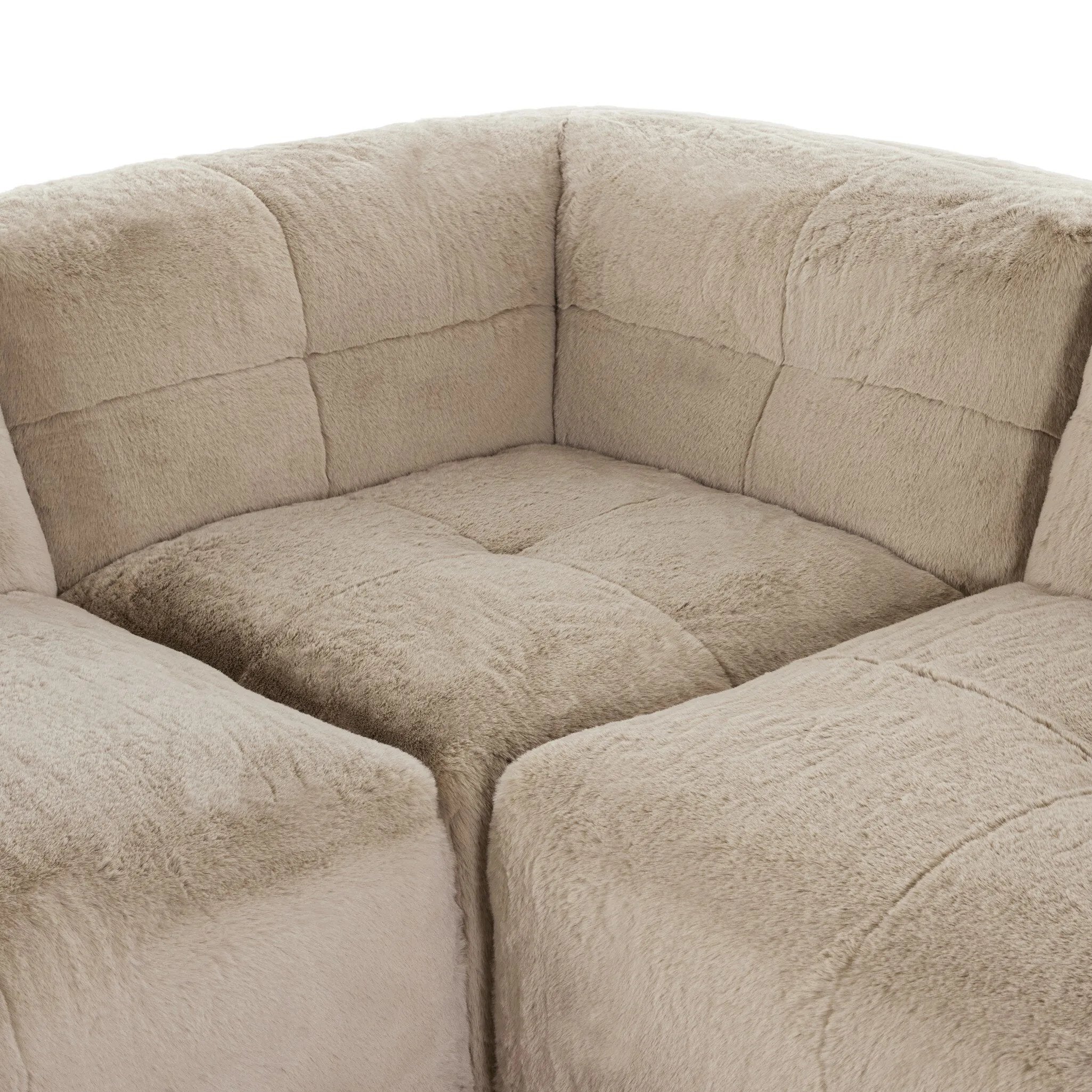 Modularity at its best, and softest. This versatile sectional includes seven pieces crafted with soft cushioning and S-spring suspension for a supportive sit. All covered in a plush, furry fabric that feels luxurious to sink into. Discreet seams add a touch of structure throughout Amethyst Home provides interior design, new home construction design consulting, vintage area rugs, and lighting in the Newport Beach metro area.