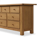 Drawing inspiration from a vintage general store counter, a storage-driven dresser reflects traditional and functional design. Thick oak legs with softened corners provide sturdy support, while oak knobs add a classic touch. An inset tray top and a versatile drawer configuration offer ample storage Amethyst Home provides interior design, new home construction design consulting, vintage area rugs, and lighting in the Calabasas metro area.