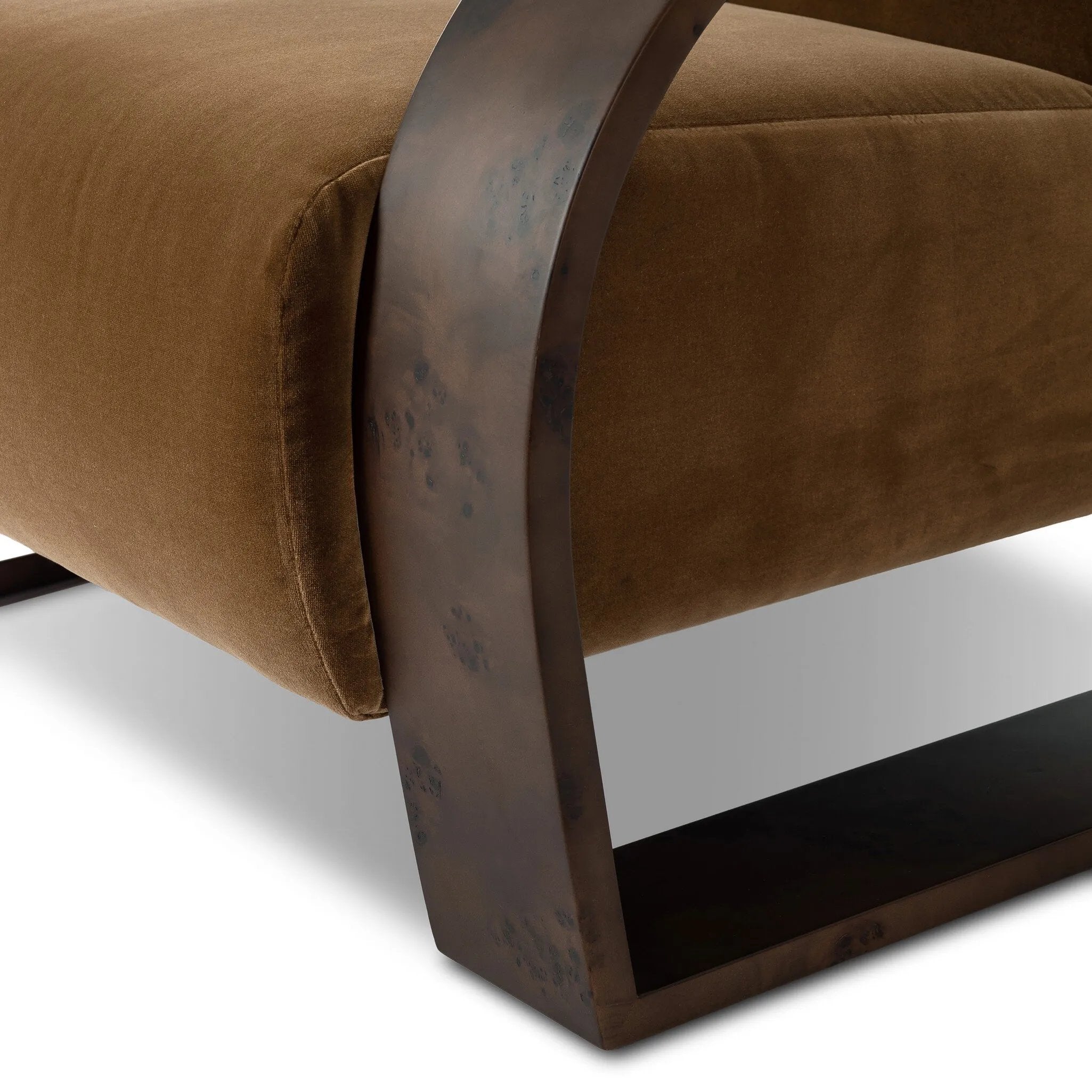 A luxe material mix at play. Deep plush seating in a high pile velvet is paired with an exaggerated 1920s Art Deco-inspired frame. Its bentwood arms are sculpted from mappa burl for extra movement throughout the piece. Amethyst Home provides interior design, new home construction design consulting, vintage area rugs, and lighting in the Los Angeles metro area.