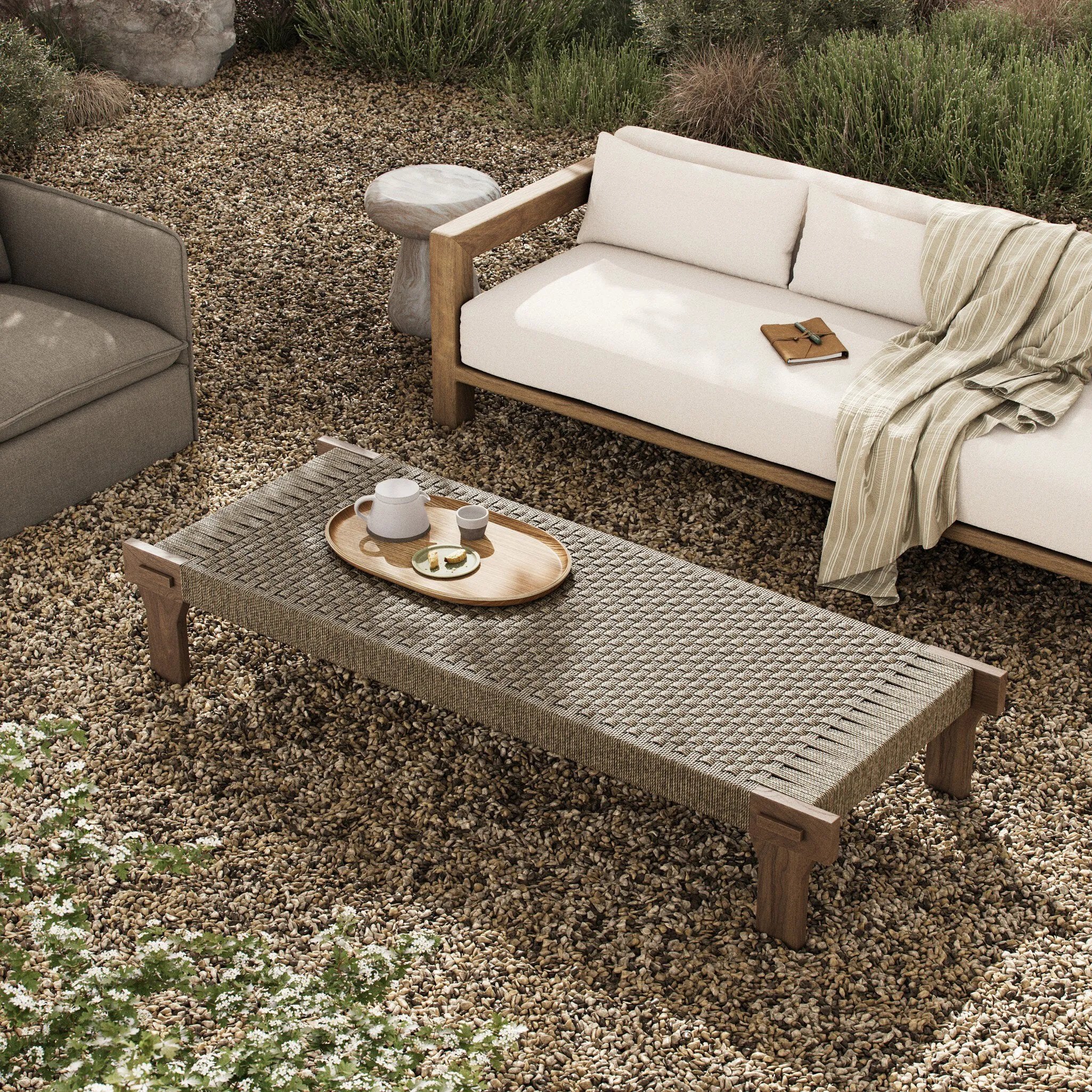 Create an outdoor space that transports you to far corners of the globe. Inspired by traditional designs found throughout Indonesia, this outdoor bench features a beautifully crafted frame made of FSC-certified solid teak with pull-through details and monochromatic weaving throughout. Amethyst Home provides interior design, new home construction design consulting, vintage area rugs, and lighting in the Miami metro area.