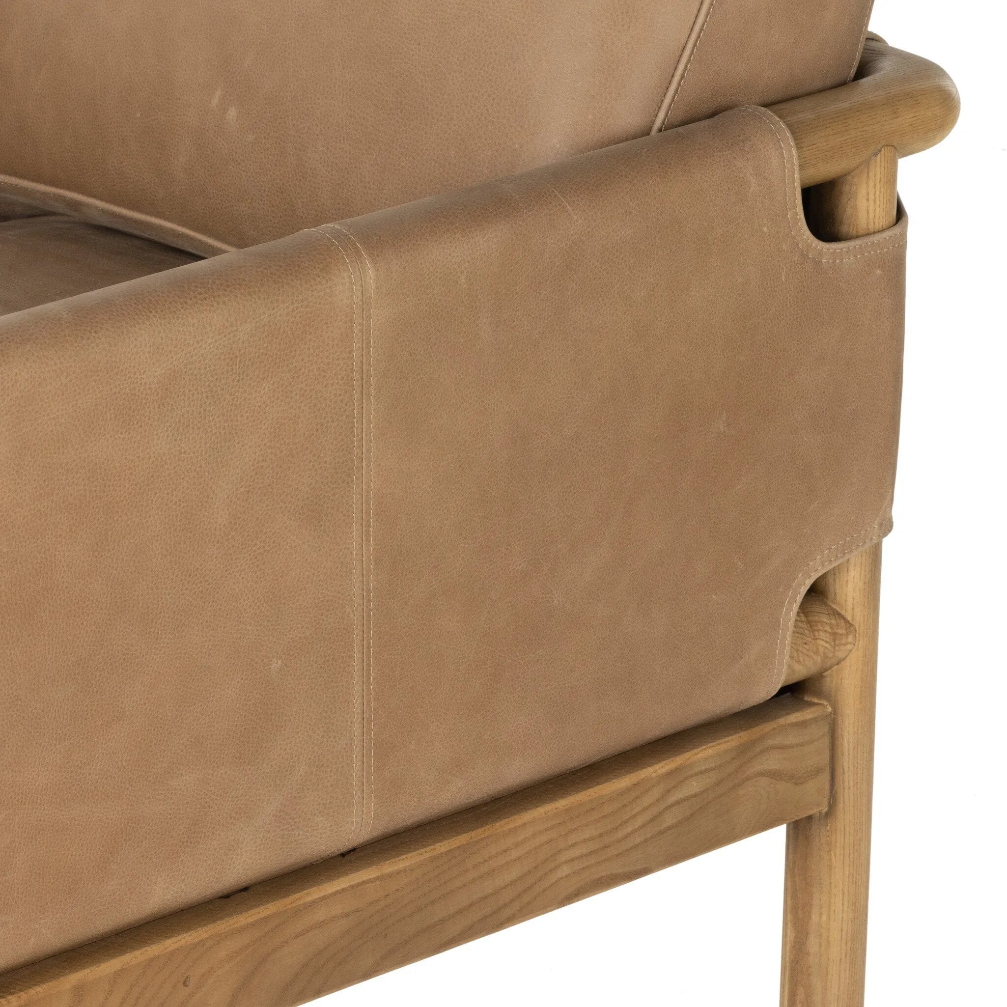 Featuring Navarro Palermo Drift Chair by Four Hands at Amethyst Home. Safari inspiration meets zen aspirations. A cylindrical frame is crafted, smoothed and rounded from solid ash wood. Includes two loose feather-blend cushions covered in subtly distressed thick cut leather in a neutral taupe hue for a monochromatic look. Overall Dimensions: 27.75"w x 34. Amethyst Home provides interior design, new home construction design consulting, vintage area rugs, and lighting in the Laguna Beach metro area.