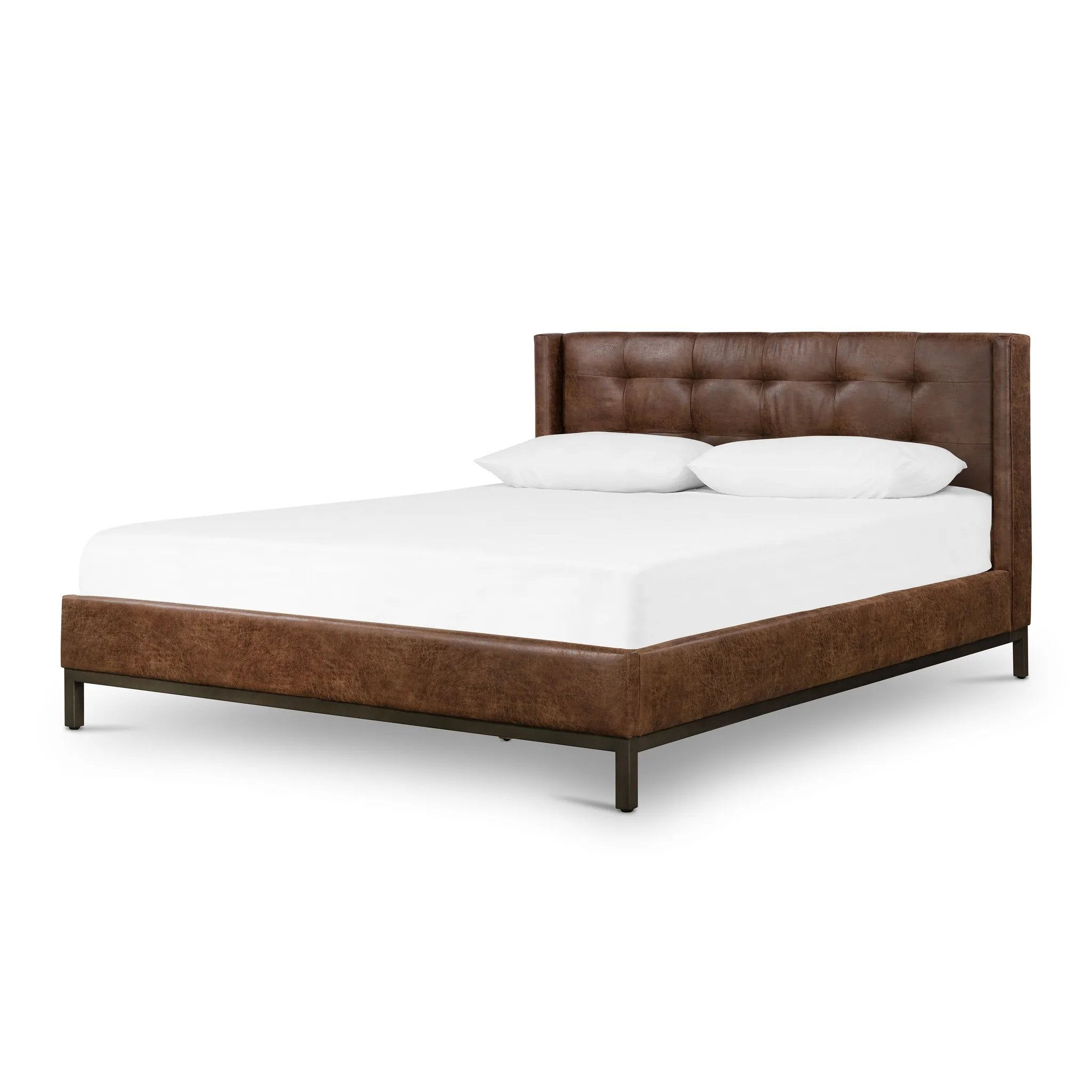 Subtle, modern elegance. A low, tufted headboard in a vintage tobacco faux leather pairs with a simple gunmetal iron base Amethyst Home provides interior design, new home construction design consulting, vintage area rugs, and lighting in the Tampa metro area.