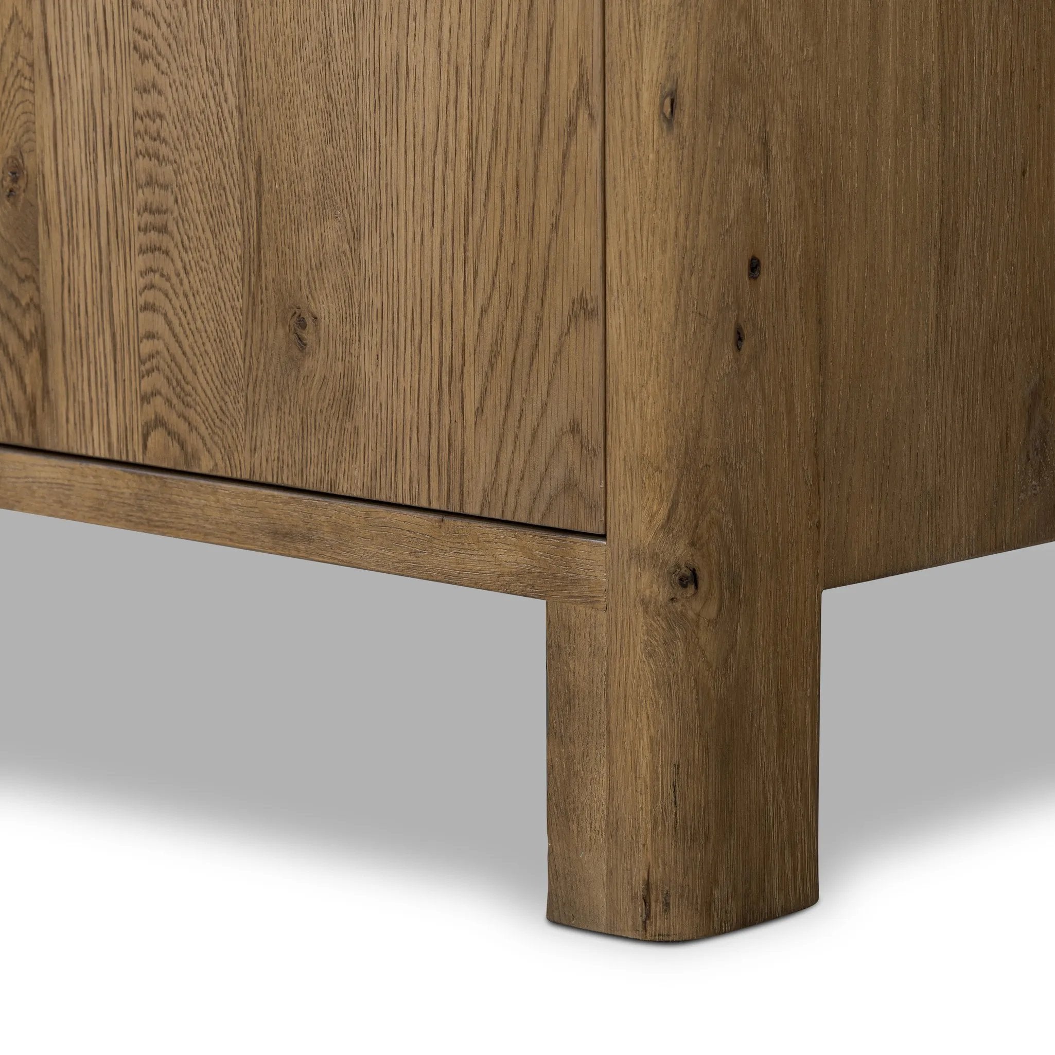 Made from resawn oak with a worn, natural finish, a long, streamlined sideboard offers ample storage space behind four push-latch doors. Subtly rounded corners add softness to otherwise clean lines, while knots and graining offer a naturally rich look. Dual rear cutouts for seamless cord management Amethyst Home provides interior design, new home construction design consulting, vintage area rugs, and lighting in the Park City metro area.