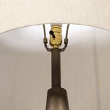 A striking silhouette. An antique brass finish highlights iron's gradual blending of hues for a distinctive ombre effect on this tapered metal base. Topped with a 100% cotton shade Amethyst Home provides interior design, new home construction design consulting, vintage area rugs, and lighting in the Miami metro area.