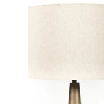 A striking silhouette. An antique brass finish highlights iron's gradual blending of hues for a distinctive ombre effect on this tapered metal base. Topped with a 100% cotton shade Amethyst Home provides interior design, new home construction design consulting, vintage area rugs, and lighting in the Tampa metro area.