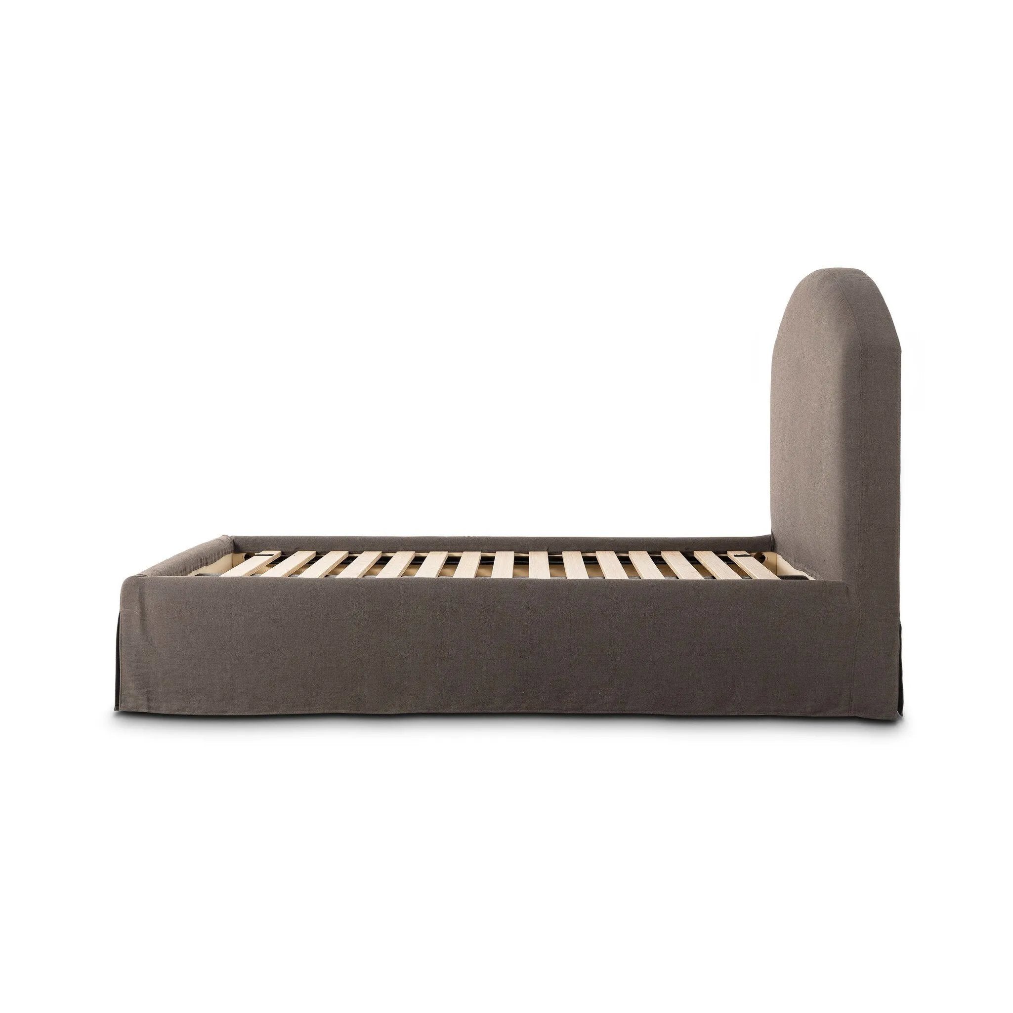 An arched headboard and simple frame act as the perfect canvas for your favorite bedding. A soft textural linen slipcover in a rich brown hue contributes a cozy yet refined look Amethyst Home provides interior design, new home construction design consulting, vintage area rugs, and lighting in the Boston metro area.