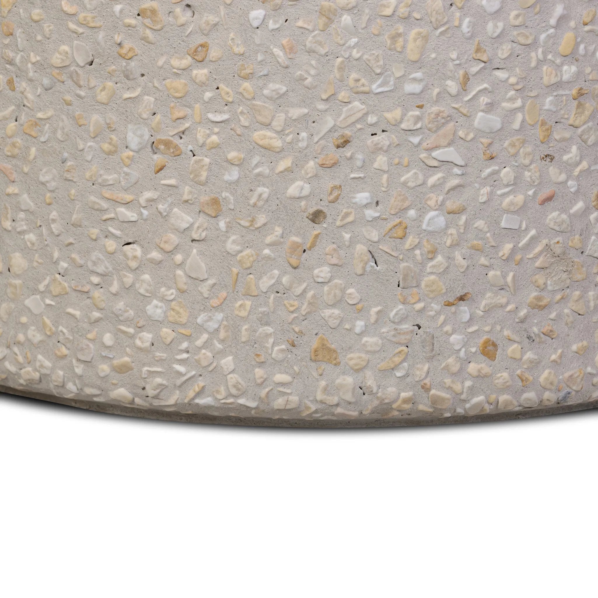 Natural stones form a neutral terrazzo pattern on a cream base, bringing a sense of texture and depth to this versatile coffee table. Designed with a clean, rounded silhouette, it works effortlessly in both indoor and outdoor spaces. Cover or store indoors during inclement weather and when not in use Amethyst Home provides interior design, new home construction design consulting, vintage area rugs, and lighting in the Nashville metro area.