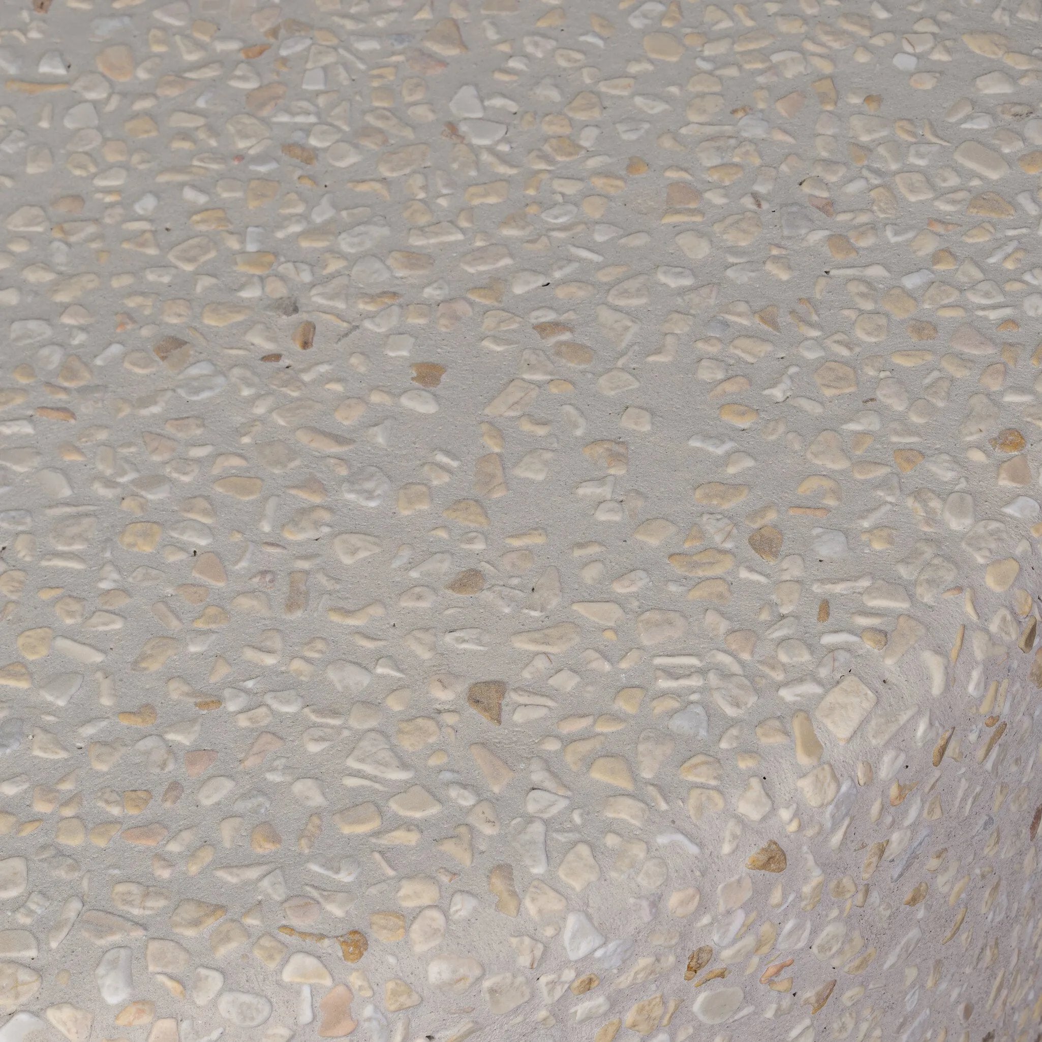 Natural stones form a neutral terrazzo pattern on a cream base, bringing a sense of texture and depth to this versatile coffee table. Designed with a clean, rounded silhouette, it works effortlessly in both indoor and outdoor spaces. Cover or store indoors during inclement weather and when not in use Amethyst Home provides interior design, new home construction design consulting, vintage area rugs, and lighting in the Park City metro area.