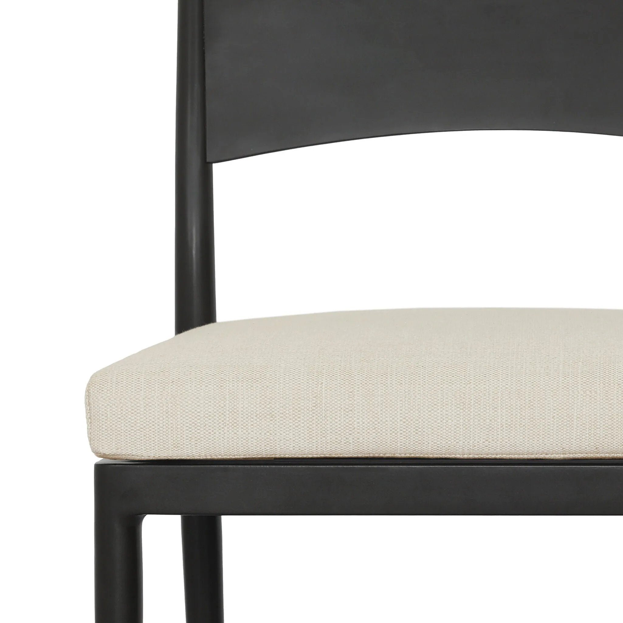 Streamlined and classic, this outdoor dining chair's simple silhouette features a subtly curved back on its matte black frame, finished with a cream linen-like seat cushion. Cover or store inside during inclement weather and when not in use. Amethyst Home provides interior design, new home construction design consulting, vintage area rugs, and lighting in the Charlotte metro area.