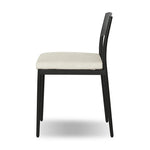 Streamlined and classic, this outdoor dining chair's simple silhouette features a subtly curved back on its matte black frame, finished with a cream linen-like seat cushion. Cover or store inside during inclement weather and when not in use. Amethyst Home provides interior design, new home construction design consulting, vintage area rugs, and lighting in the Miami metro area.
