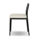 Streamlined and classic, this outdoor dining chair's simple silhouette features a subtly curved back on its matte black frame, finished with a cream linen-like seat cushion. Cover or store inside during inclement weather and when not in use. Amethyst Home provides interior design, new home construction design consulting, vintage area rugs, and lighting in the Miami metro area.