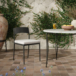 Streamlined and classic, this outdoor dining chair's simple silhouette features a subtly curved back on its matte black frame, finished with a cream linen-like seat cushion. Cover or store inside during inclement weather and when not in use. Amethyst Home provides interior design, new home construction design consulting, vintage area rugs, and lighting in the San Diego metro area.