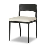 Streamlined and classic, this outdoor dining chair's simple silhouette features a subtly curved back on its matte black frame, finished with a cream linen-like seat cushion. Cover or store inside during inclement weather and when not in use. Amethyst Home provides interior design, new home construction design consulting, vintage area rugs, and lighting in the Tampa metro area.
