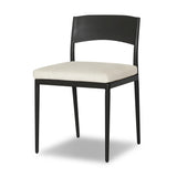 Streamlined and classic, this outdoor dining chair's simple silhouette features a subtly curved back on its matte black frame, finished with a cream linen-like seat cushion. Cover or store inside during inclement weather and when not in use. Amethyst Home provides interior design, new home construction design consulting, vintage area rugs, and lighting in the Tampa metro area.