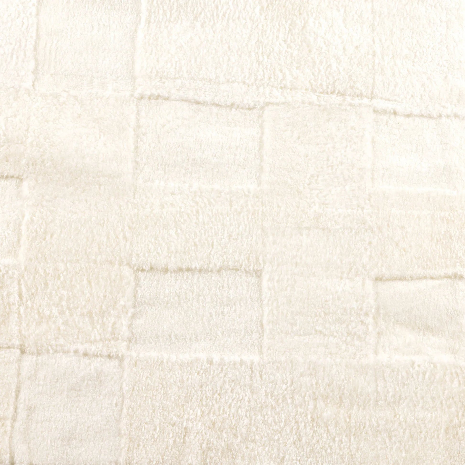 Patchwork Cream Shorn Shearling Rug is shaved to different heights and stitched together to create a tonal checked pattern for a modern yet classic look. Subtle color variations bring a natural, more organic feel to the rug. The material, pattern, and hues come together to craft an unexpected bold style Amethyst Home provides interior design, new home construction design consulting, vintage area rugs, and lighting in the Miami metro area.