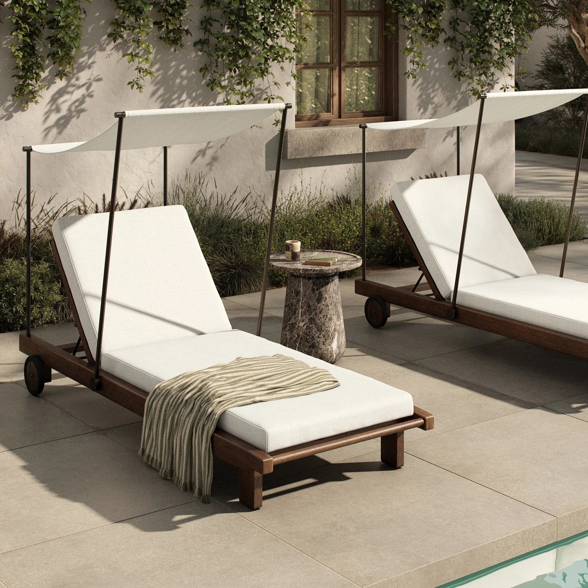 Drawing inspiration from antique rickshaws, this outdoor chaise features wheels and a built-in handle at the front for easy mobility. The adjustable and removable shade canopy offers customizable sun protection, with style. Cover or store inside during inclement weather and when not in use. Amethyst Home provides interior design, new home construction design consulting, vintage area rugs, and lighting in the Boston metro area.