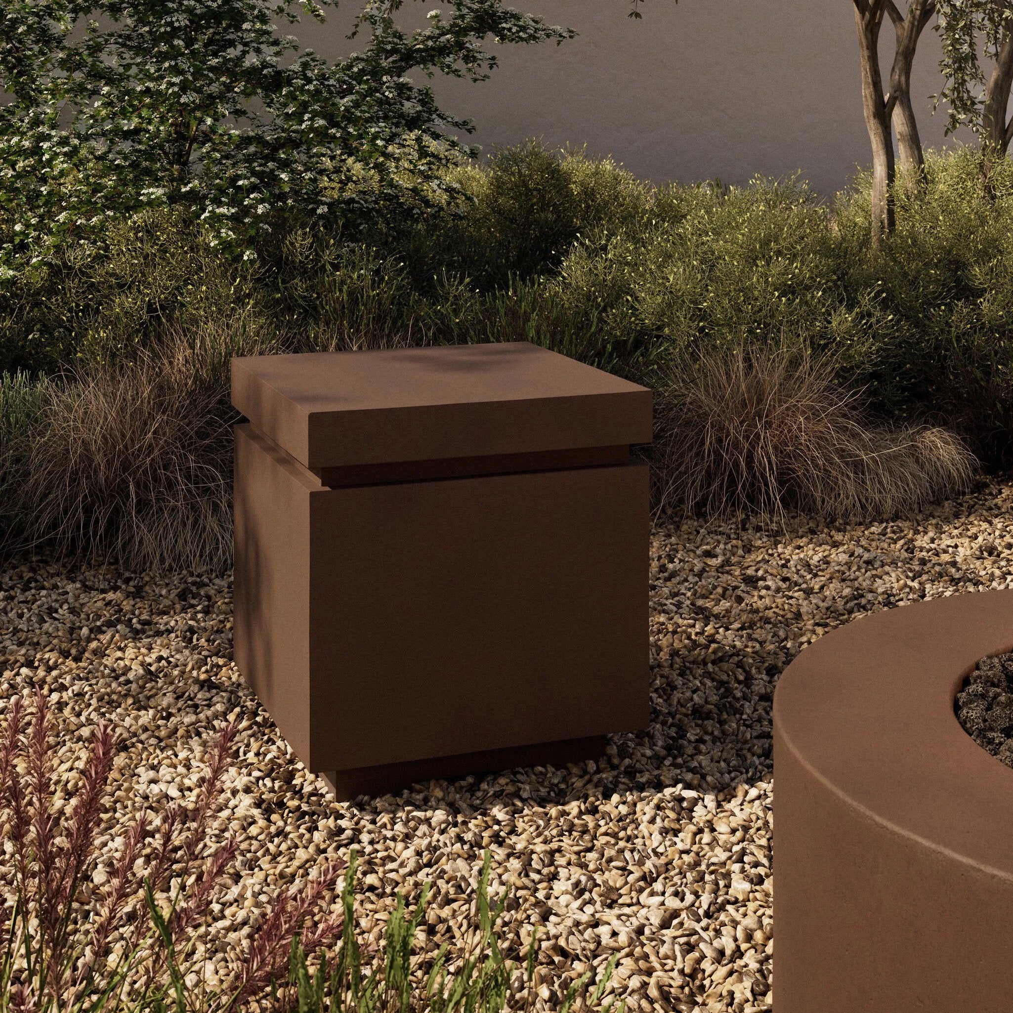 This outdoor propane tank enclosure pairs with fire tables for a clean, seamless look. Made from glass-reinforced concrete, each piece is naturally finished with deep tones of pewter and dark grey. It can act as an end table with its lid on, and has cutouts at the base for hose attachments. Amethyst Home provides interior design, new home construction design consulting, vintage area rugs, and lighting in the Salt Lake City metro area.