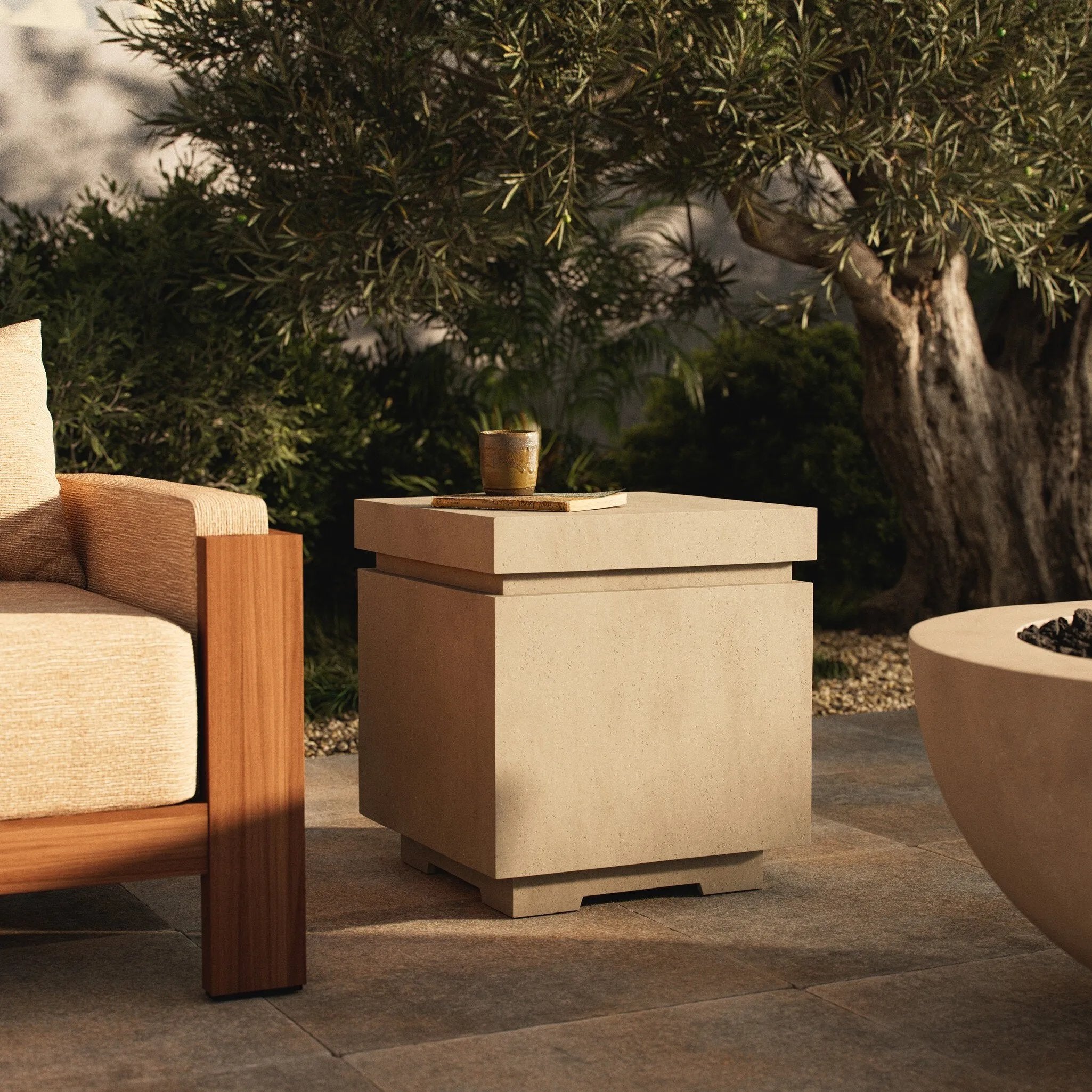 This outdoor propane tank enclosure pairs with fire tables for a clean, seamless look. Made from glass-reinforced concrete, each piece is naturally finished with subtle tones of grey and cream. It can act as an end table with its lid on, and has cutouts at the base for hose attachments. Amethyst Home provides interior design, new home construction design consulting, vintage area rugs, and lighting in the San Diego metro area.