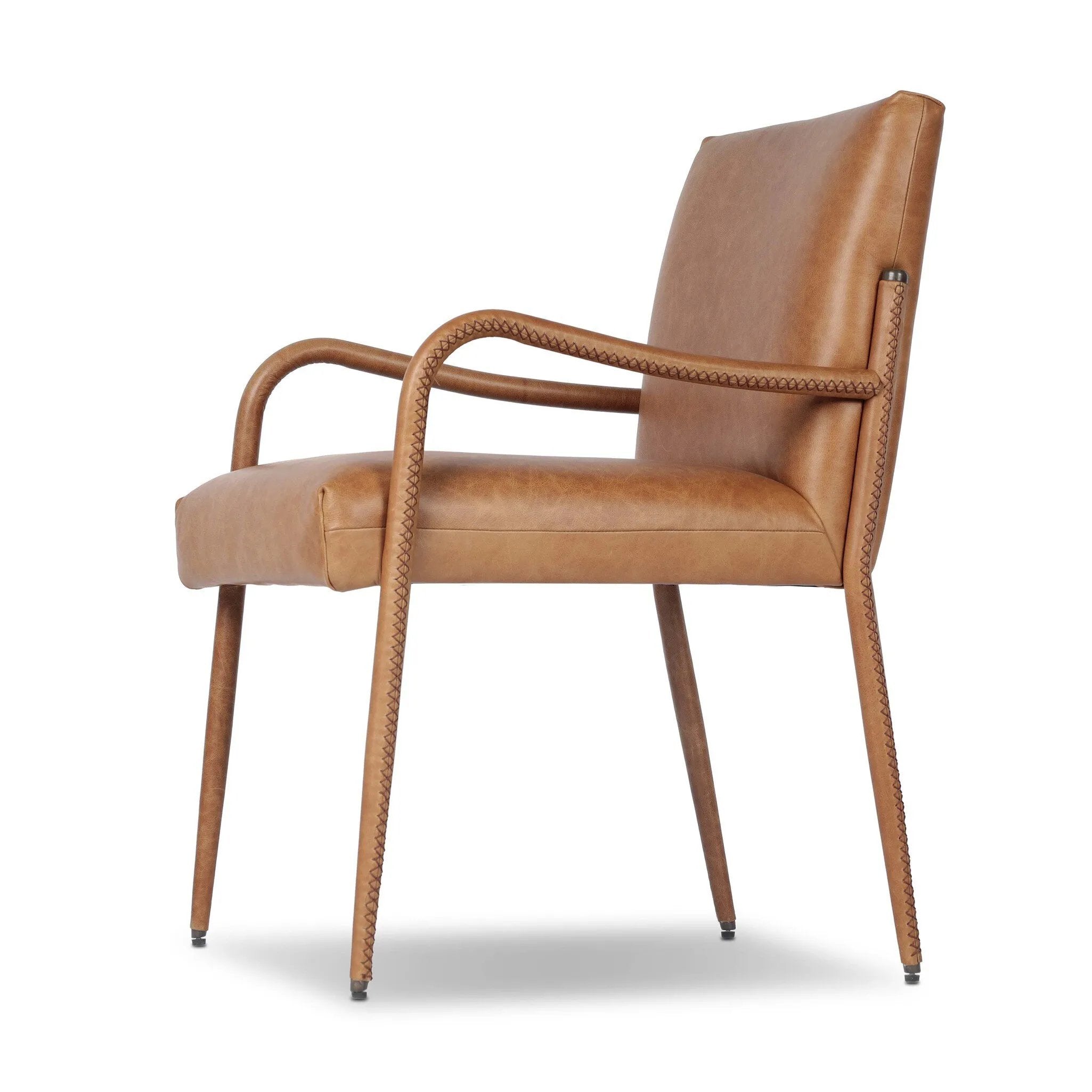 A slim seating style with timeless materials. An armless chair is fully upholstered in butterscotch top-grain leather with a subtle vintage look. Iron legs are also covered in leather, with exposed stitching along each leg. Finished with wooden armrests prime for the head of the table. Amethyst Home provides interior design, new home construction design consulting, vintage area rugs, and lighting in the Alpharetta metro area.
