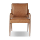 A slim seating style with timeless materials. An armless chair is fully upholstered in butterscotch top-grain leather with a subtle vintage look. Iron legs are also covered in leather, with exposed stitching along each leg. Finished with wooden armrests prime for the head of the table. Amethyst Home provides interior design, new home construction design consulting, vintage area rugs, and lighting in the Boston metro area.