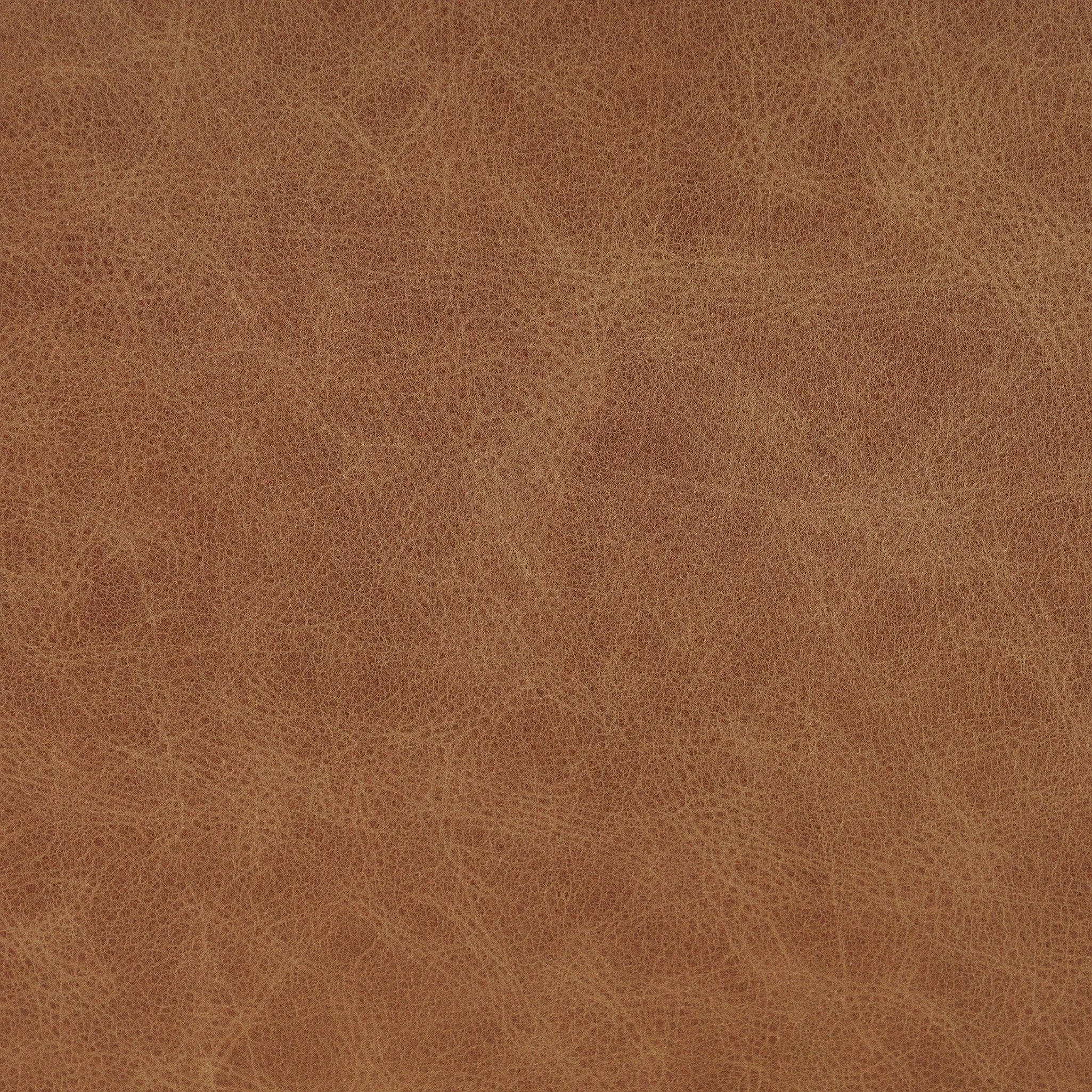 A slim seating style with timeless materials. An armless chair is fully upholstered in butterscotch top-grain leather with a subtle vintage look. Iron legs are also covered in leather, with exposed stitching along each leg. Finished with wooden armrests prime for the head of the table. Amethyst Home provides interior design, new home construction design consulting, vintage area rugs, and lighting in the Scottsdale metro area.