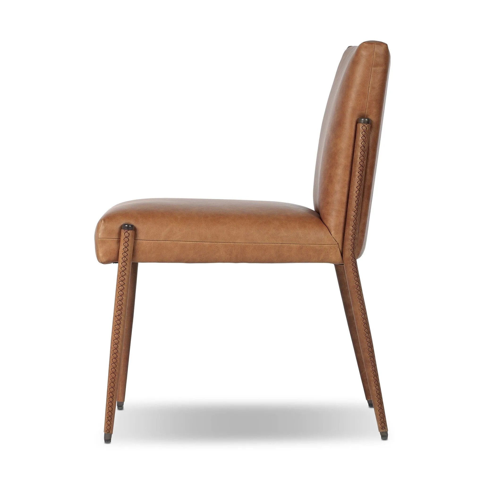 A slim seating style with timeless materials. An armless chair is fully upholstered in butterscotch top-grain leather with a subtle vintage look. Iron legs are also covered in leather, with exposed stitching along each leg.As enthusiasts of luxe design at Amethyst, we love the warm modern inspired Quill Dining Chair. Amethyst Home provides interior design, new home construction design consulting, vintage area rugs, and lighting in the Laguna Beach metro area.