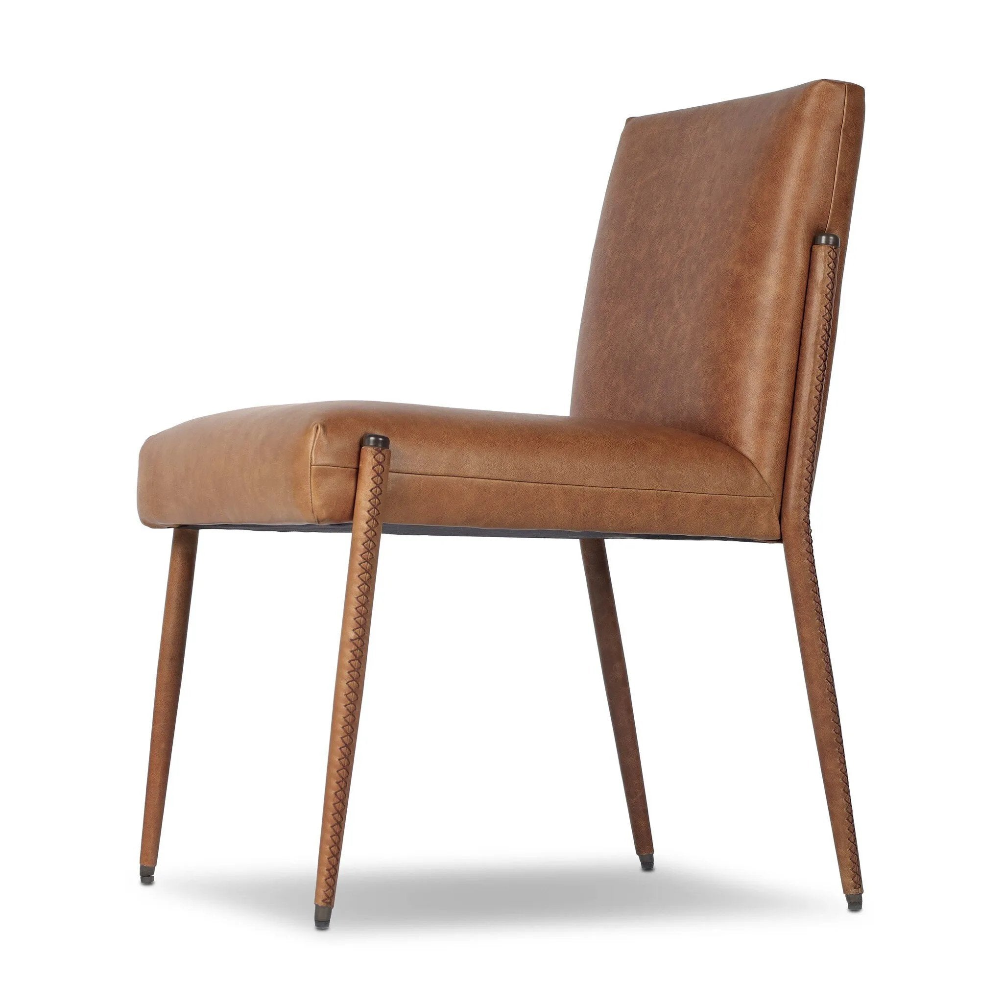 A slim seating style with timeless materials. An armless chair is fully upholstered in butterscotch top-grain leather with a subtle vintage look. Iron legs are also covered in leather, with exposed stitching along each leg.As enthusiasts of luxe design at Amethyst, we love the warm modern inspired Quill Dining Chair. Amethyst Home provides interior design, new home construction design consulting, vintage area rugs, and lighting in the Nashville metro area.