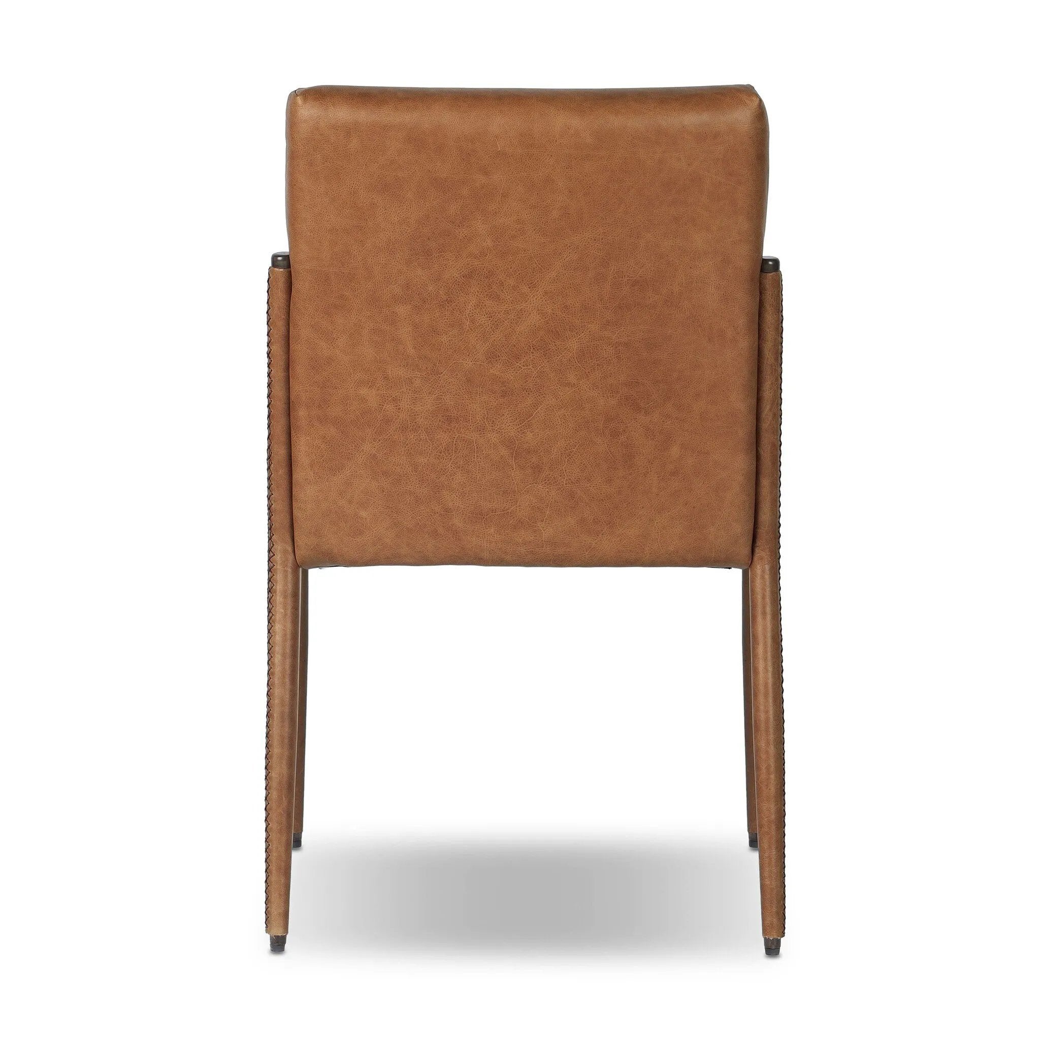 A slim seating style with timeless materials. An armless chair is fully upholstered in butterscotch top-grain leather with a subtle vintage look. Iron legs are also covered in leather, with exposed stitching along each leg.As enthusiasts of luxe design at Amethyst, we love the warm modern inspired Quill Dining Chair. Amethyst Home provides interior design, new home construction design consulting, vintage area rugs, and lighting in the Portland metro area.