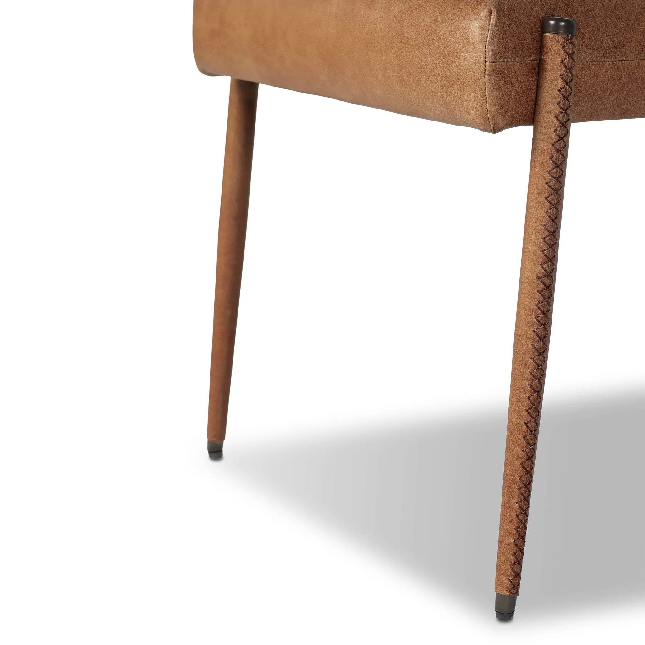 A slim seating style with timeless materials. An armless chair is fully upholstered in butterscotch top-grain leather with a subtle vintage look. Iron legs are also covered in leather, with exposed stitching along each leg.As enthusiasts of luxe design at Amethyst, we love the warm modern inspired Quill Dining Chair. Amethyst Home provides interior design, new home construction design consulting, vintage area rugs, and lighting in the Winter Garden metro area.