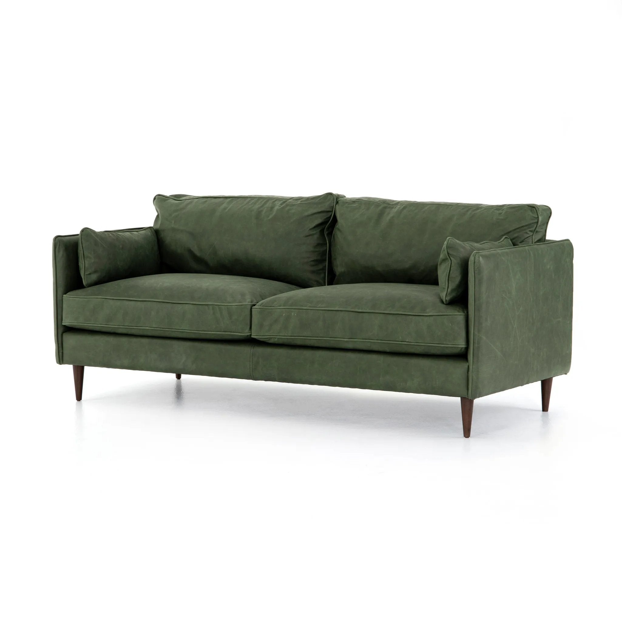 Featuring Reese Eden Sage Sofa by Four Hands at Amethyst Home. Effortlessly on-trend. Two-cushion seating of sage top-grain leather, with knife-edge pillows and welted track arms. Almond-finished legs taper for a modern touch atop mid-century influence.Overall Dimensions: 76.00"w x 35.00"d x 32.75"hWeight : 110.89 lbsMaterials: Top Grain Leather, Poplar . Amethyst Home provides interior design, new home construction design consulting, vintage area rugs, and lighting in the Laguna Beach metro area.