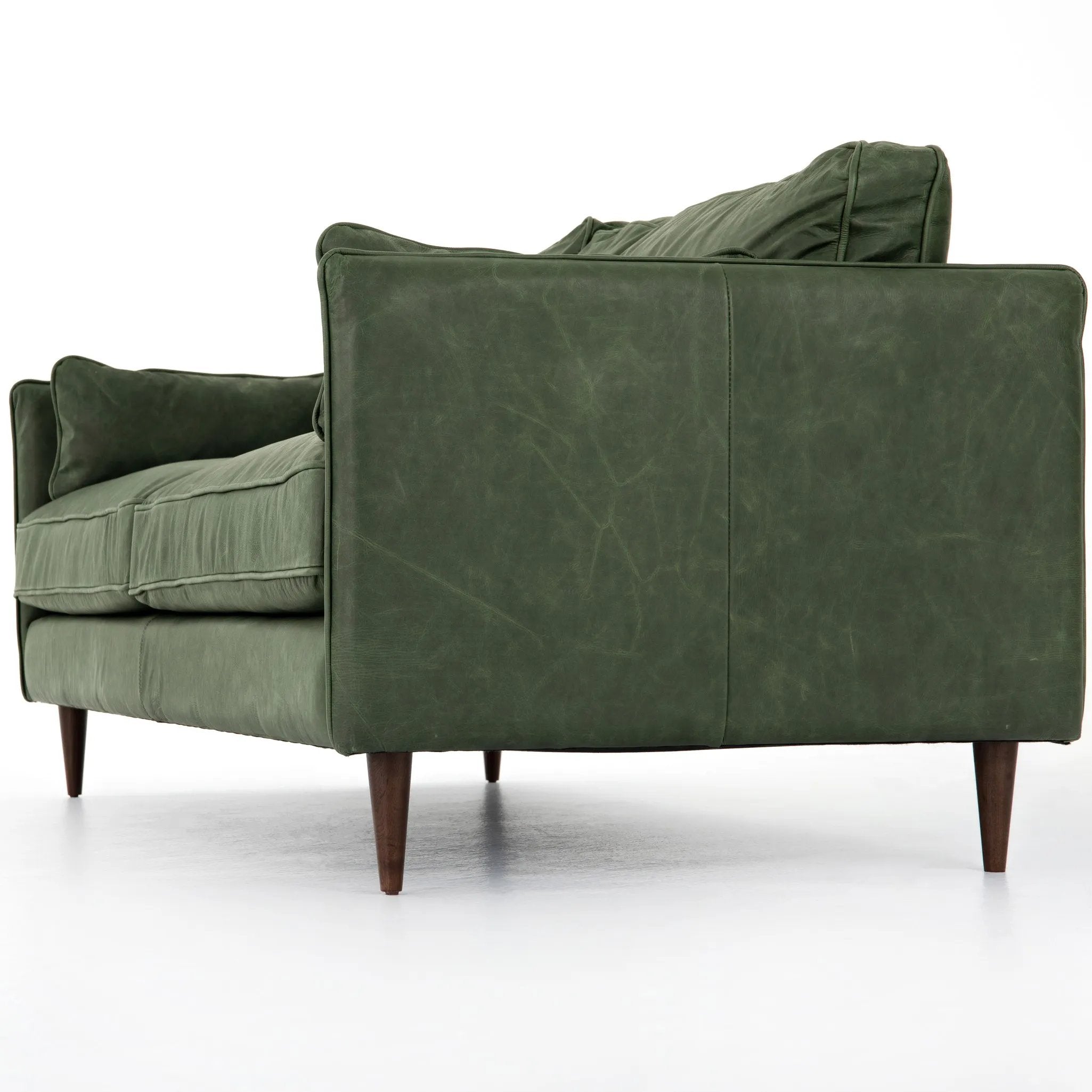 Featuring Reese Eden Sage Sofa by Four Hands at Amethyst Home. Effortlessly on-trend. Two-cushion seating of sage top-grain leather, with knife-edge pillows and welted track arms. Almond-finished legs taper for a modern touch atop mid-century influence.Overall Dimensions: 76.00"w x 35.00"d x 32.75"hWeight : 110.89 lbsMaterials: Top Grain Leather, Poplar Plywood. Amethyst Home provides interior design, new home construction design consulting, vintage area rugs, and lighting in the Omaha metro area.