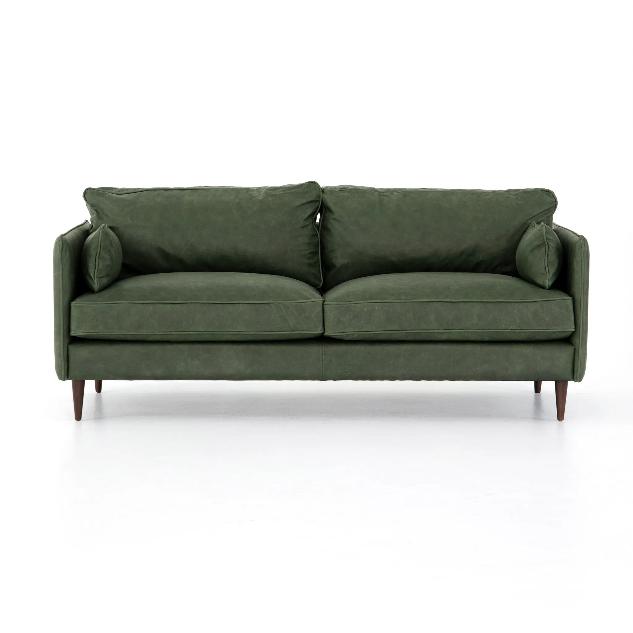 Featuring Reese Eden Sage Sofa by Four Hands at Amethyst Home. Effortlessly on-trend. Two-cushion seating of sage top-grain leather, with knife-edge pillows and welted track arms. Almond-finished legs taper for a modern touch atop mid-century influence.Overall Dimensions: 76.00"w x 35.00"d x 32.75"hWeight : 110.89 lbsMaterials: Top Grain Leather, Poplar. Amethyst Home provides interior design, new home construction design consulting, vintage area rugs, and lighting in the Winter Garden metro area.