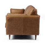 Featuring Reese Palermo Cognac Sofa by Four Hands at Amethyst Home. Effortlessly on-trend. Two-cushion seating of top-grain leather, with knife-edge pillows and welted track arms. Almond-finished legs taper for a modern touch atop midcentury influence.Overall Dimensions: 76.00"w x 35.00"d x 32.75"hWeight : 110.89 lbsMaterials: Top Grain Leather, Poplar Plywo. Amethyst Home provides interior design, new home construction design consulting, vintage area rugs, and lighting in the Monterey metro area.