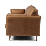 Featuring Reese Palermo Cognac Sofa by Four Hands at Amethyst Home. Effortlessly on-trend. Two-cushion seating of top-grain leather, with knife-edge pillows and welted track arms. Almond-finished legs taper for a modern touch atop midcentury influence.Overall Dimensions: 76.00"w x 35.00"d x 32.75"hWeight : 110.89 lbsMaterials: Top Grain Leather, Poplar Plywo. Amethyst Home provides interior design, new home construction design consulting, vintage area rugs, and lighting in the Monterey metro area.