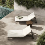 A campaign-inspired outdoor chaise transforms any space into your personal retreat. Monochromatic strap detailing wraps a sleek, minimalist frame, with a linen-like cushion upholstered in high-performance Italian fabric. Designed to elevate your outdoor space with a resort-like ease. Amethyst Home provides interior design, new home construction design consulting, vintage area rugs, and lighting in the Alpharetta metro area.