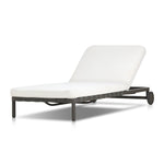 A campaign-inspired outdoor chaise transforms any space into your personal retreat. Monochromatic strap detailing wraps a sleek, minimalist frame, with a linen-like cushion upholstered in high-performance Italian fabric. Designed to elevate your outdoor space with a resort-like ease. Amethyst Home provides interior design, new home construction design consulting, vintage area rugs, and lighting in the Calabasas metro area.