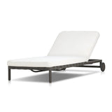 A campaign-inspired outdoor chaise transforms any space into your personal retreat. Monochromatic strap detailing wraps a sleek, minimalist frame, with a linen-like cushion upholstered in high-performance Italian fabric. Designed to elevate your outdoor space with a resort-like ease. Amethyst Home provides interior design, new home construction design consulting, vintage area rugs, and lighting in the Calabasas metro area.