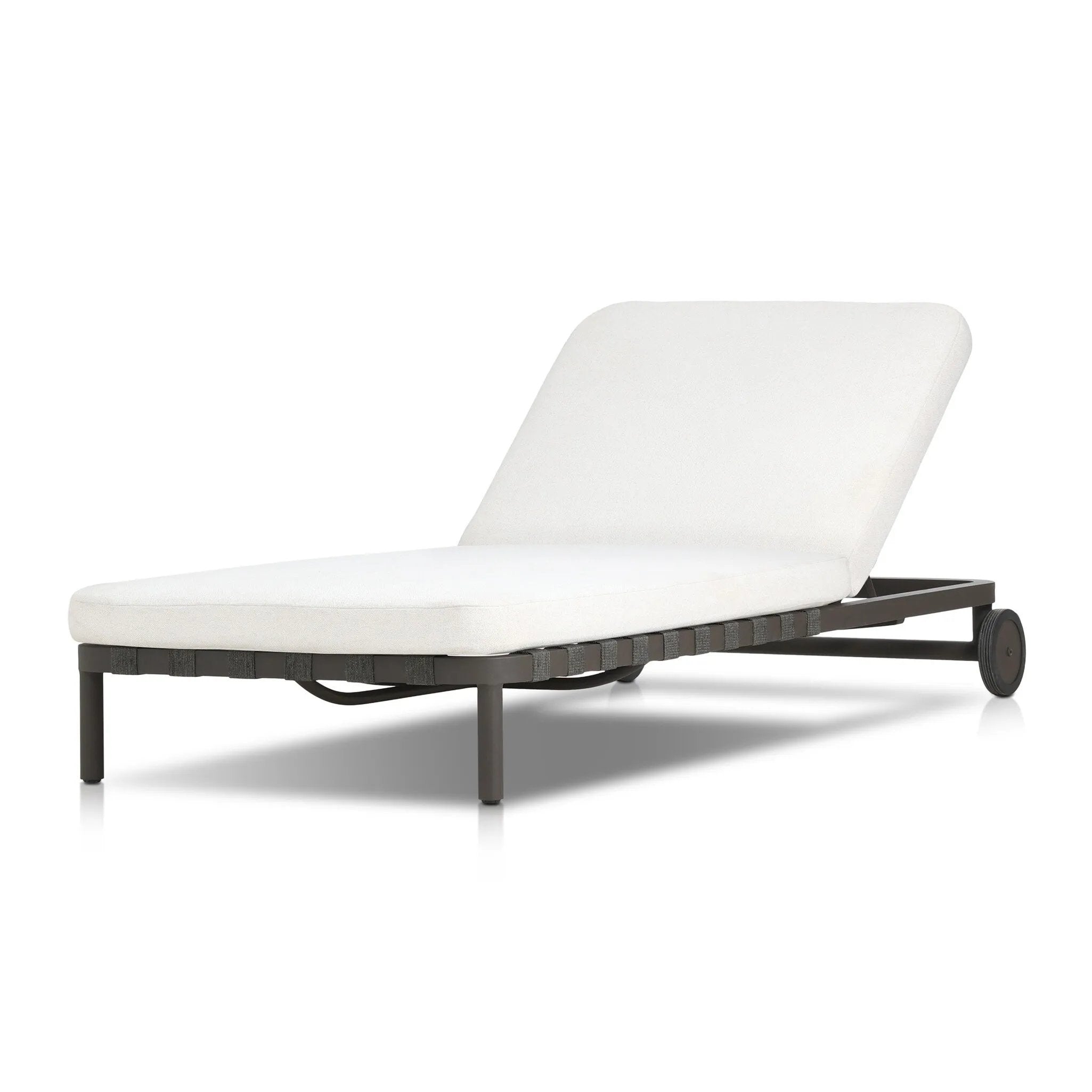 A campaign-inspired outdoor chaise transforms any space into your personal retreat. Monochromatic strap detailing wraps a sleek, minimalist frame, with a linen-like cushion upholstered in high-performance Italian fabric. Designed to elevate your outdoor space with a resort-like ease. Amethyst Home provides interior design, new home construction design consulting, vintage area rugs, and lighting in the Calabasas metro area.