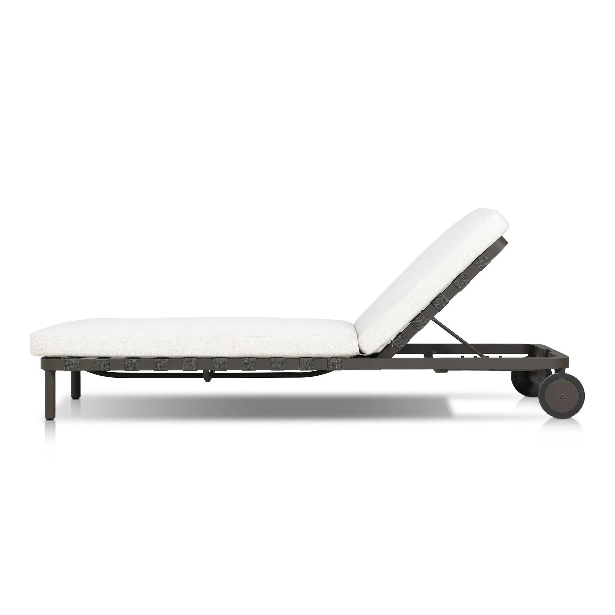 A campaign-inspired outdoor chaise transforms any space into your personal retreat. Monochromatic strap detailing wraps a sleek, minimalist frame, with a linen-like cushion upholstered in high-performance Italian fabric. Designed to elevate your outdoor space with a resort-like ease. Amethyst Home provides interior design, new home construction design consulting, vintage area rugs, and lighting in the Houston metro area.
