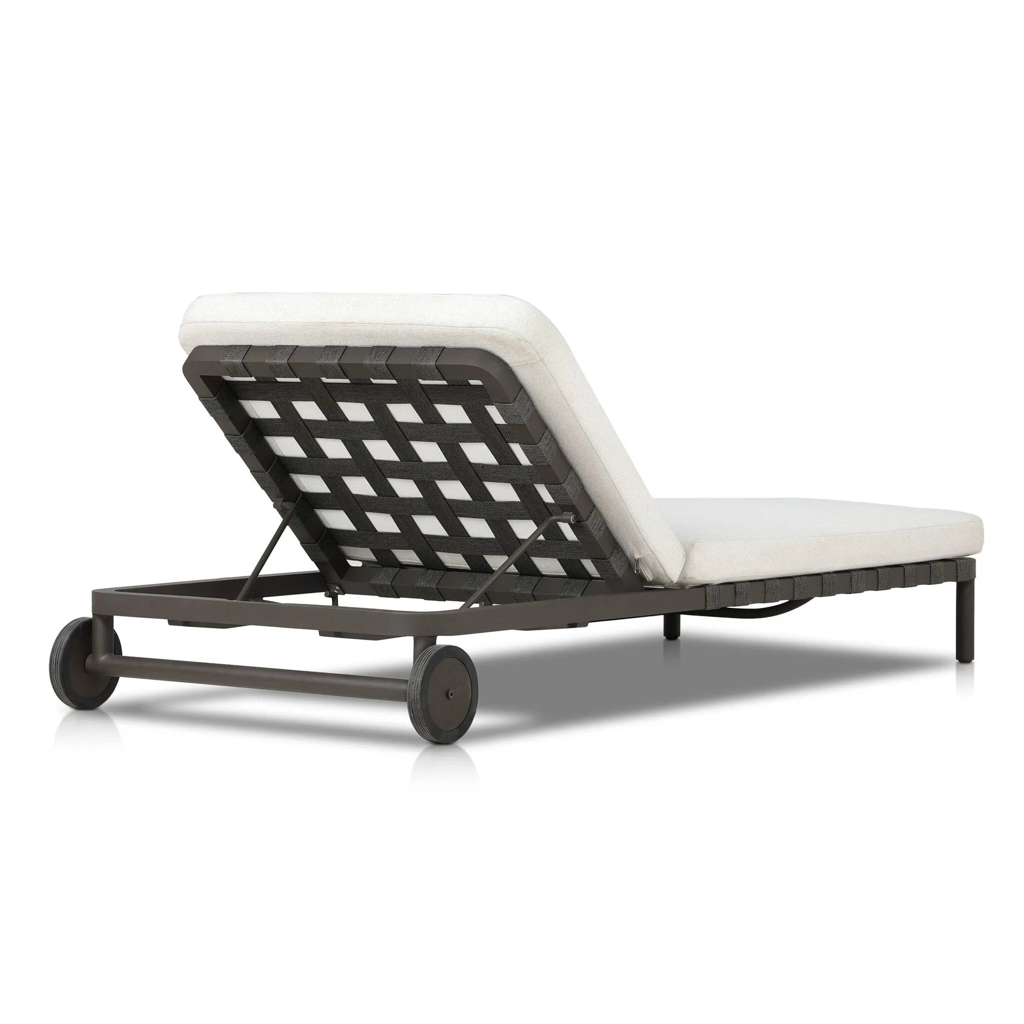 A campaign-inspired outdoor chaise transforms any space into your personal retreat. Monochromatic strap detailing wraps a sleek, minimalist frame, with a linen-like cushion upholstered in high-performance Italian fabric. Designed to elevate your outdoor space with a resort-like ease. Amethyst Home provides interior design, new home construction design consulting, vintage area rugs, and lighting in the Kansas City metro area.
