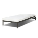 A campaign-inspired outdoor chaise transforms any space into your personal retreat. Monochromatic strap detailing wraps a sleek, minimalist frame, with a linen-like cushion upholstered in high-performance Italian fabric. Designed to elevate your outdoor space with a resort-like ease. Amethyst Home provides interior design, new home construction design consulting, vintage area rugs, and lighting in the Winter Garden metro area.