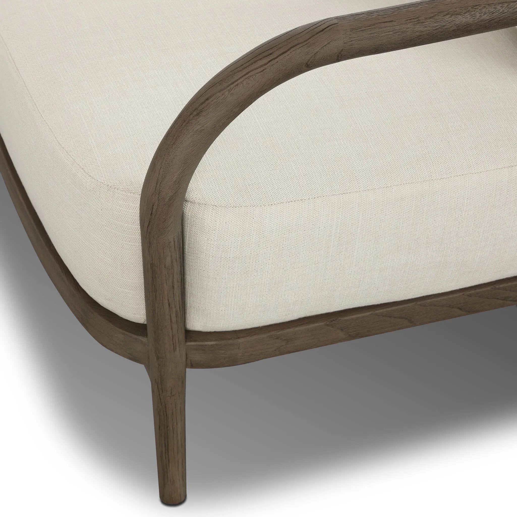 Capturing the ease of tropical ratan seating, an oversized outdoor chair is shaped from FSC-certified teak and wrapped with rush cord detailing. Exemplary woodworking is seen in the fluid lines that end with sturdy spindle legs supporting the comfortable S-spring fixed seat and loose cushion, upholstered in taupe burlap fabric. Amethyst Home provides interior design, new home construction design consulting, vintage area rugs, and lighting in the Laguna Beach metro area.
