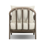 Capturing the ease of tropical ratan seating, an oversized outdoor chair is shaped from FSC-certified teak and wrapped with rush cord detailing. Exemplary woodworking is seen in the fluid lines that end with sturdy spindle legs supporting the comfortable S-spring fixed seat and loose cushion, upholstered in taupe burlap fabric. Amethyst Home provides interior design, new home construction design consulting, vintage area rugs, and lighting in the Los Angeles metro area.
